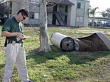 Code officer writing up a dumping violation.