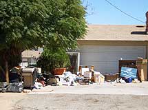 Trash outside a home's garage.