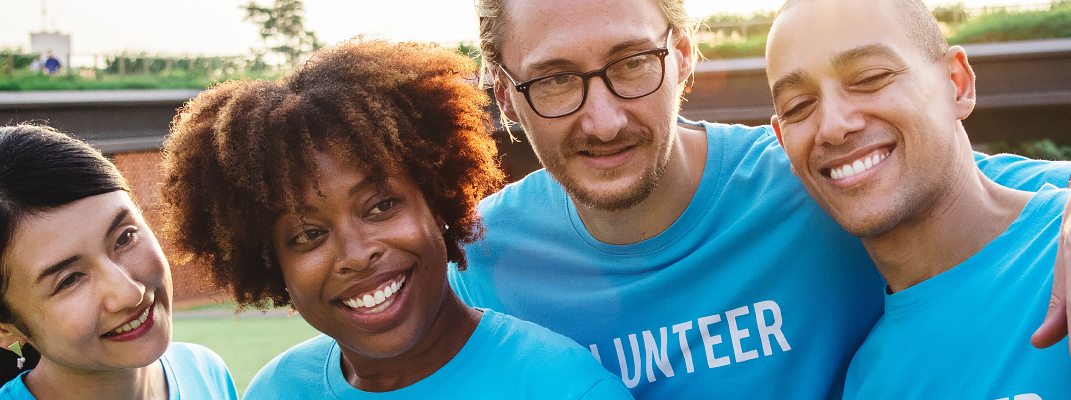 Four volunteers wearing blue t-shirts.